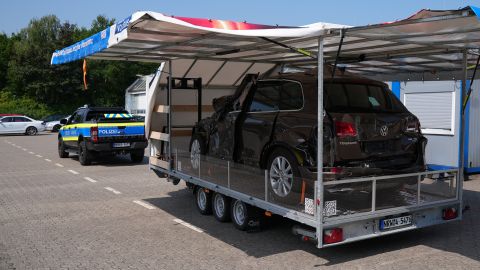 Kampagnenfahrzeug von schräg hinten aufgenommen. Die Seitenwände sind hochgeklappt. Zu sehen ist ein Fahrzeug mit Totalschaden